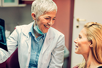 Our dentist going over post-operative instructions with a patient at Solutions Dental Implants in Sun City West, AZ