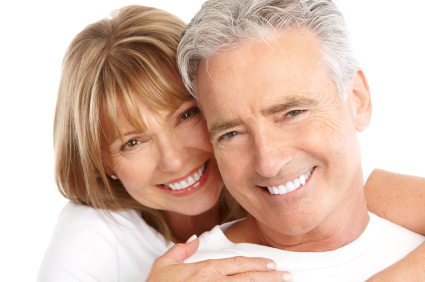 Couple smiling after getting new dental implants at Solutions Dental Implants in Sun City West, AZ Couple smiling after getting new dental implants at Solutions Dental Implants in Sun City West, AZ