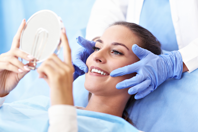 A patient smiling after receiving dental implant at Solutions Dental Implants in Sun City West, AZ